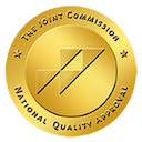 Illustration of gold coin with The Joint Commission logo on it