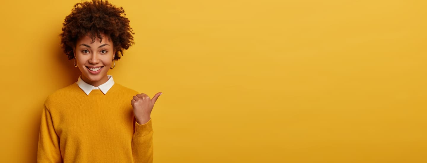 Person smiling and pointing
