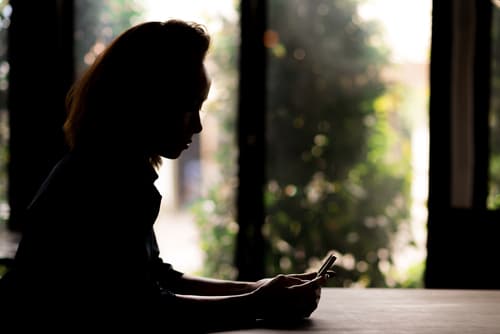 Profile of woman on her cell phone