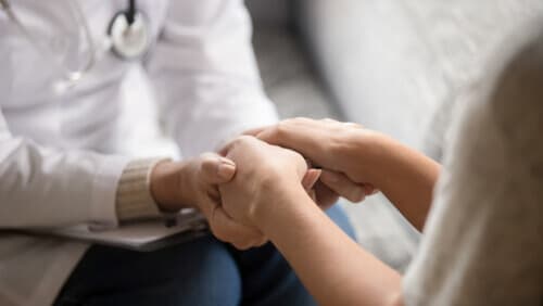 Doctor holding patient's hands