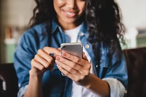 woman scrolling on cell phone