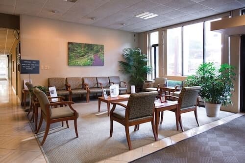 Lobby seating area with chairs in rectangle on carpet