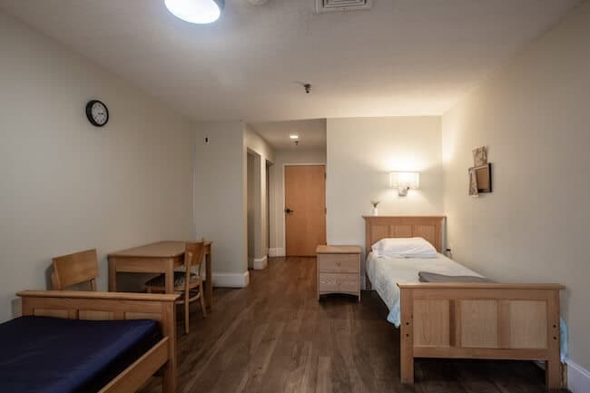 Bedroom with wood furniture and wall sconce