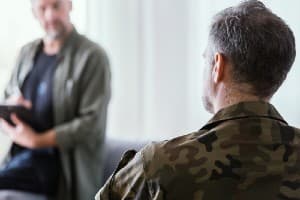 Veteran talking to therapist about his need for trauma based therapy