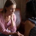 woman talking with counselor about trauma and addiction