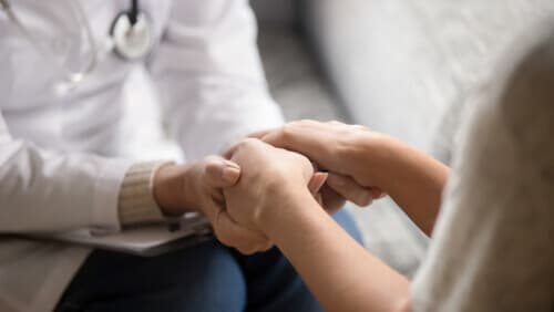 Doctor hold patient's hands