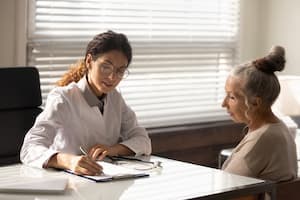 Woman talking to doctor about insurance