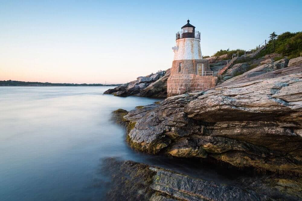 New England coast with rocky shore and a lighthouse along the ocean